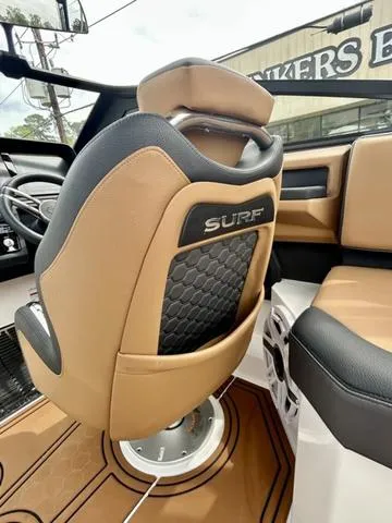 Slide: The Image of 2023 Cobalt R6 Surf boat interior with tan and black seating. - 35