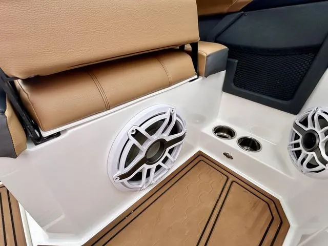 Slide: The Image of 2023 Cobalt R6 Surf boat interior with speakers and tan seating. - 36