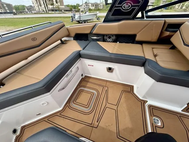 Slide: The Image of 2023 Cobalt R6 Surf boat interior with tan and black seating, modern design, and spacious layout. - 41