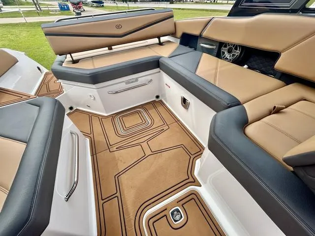Slide: The Image of 2023 Cobalt R6 Surf boat interior with tan and black seating, stylish flooring, and modern design. - 42