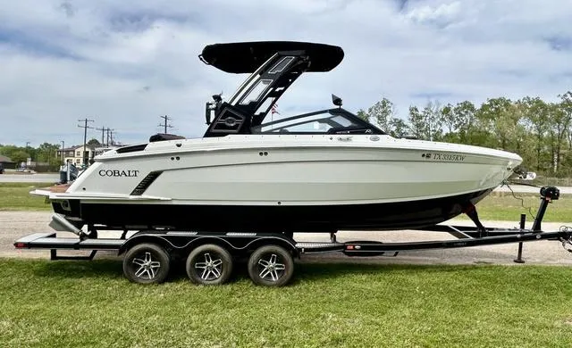 Slide: The Image of 2023 Cobalt R6 Surf boat on trailer, parked on grass, side view. - 5