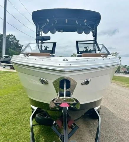 Slide: The Image of 2023 Cobalt R6 Surf boat, front view, on a trailer, outdoors. - 6