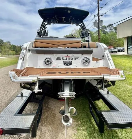 Slide: The Image of 2023 Cobalt R6 Surf boat on trailer, rear view, showcasing sleek design and surf features. - 7