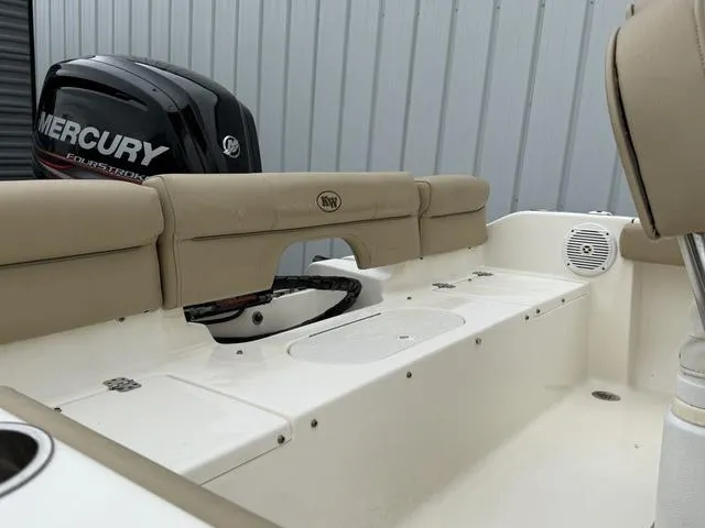 Slide: The Image of 2016 Key West 189FS boat interior with Mercury engine, beige seating, and white deck. - 15