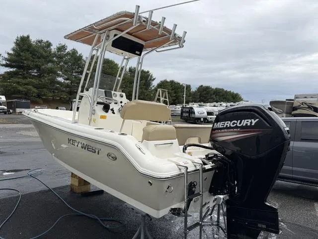 Slide: The Image of 2016 Key West 189FS boat with Mercury engine, parked outdoors on a cloudy day. - 3
