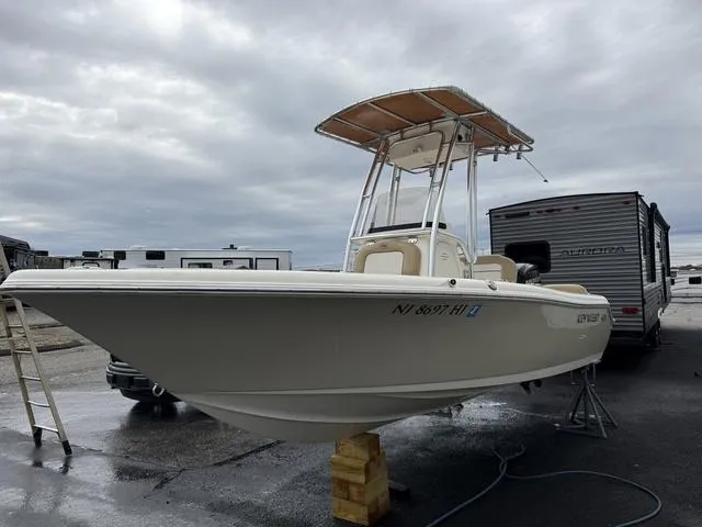 Slide: The Image of 2016 Key West 189FS boat on blocks, parked near trailers under cloudy skies. - 4
