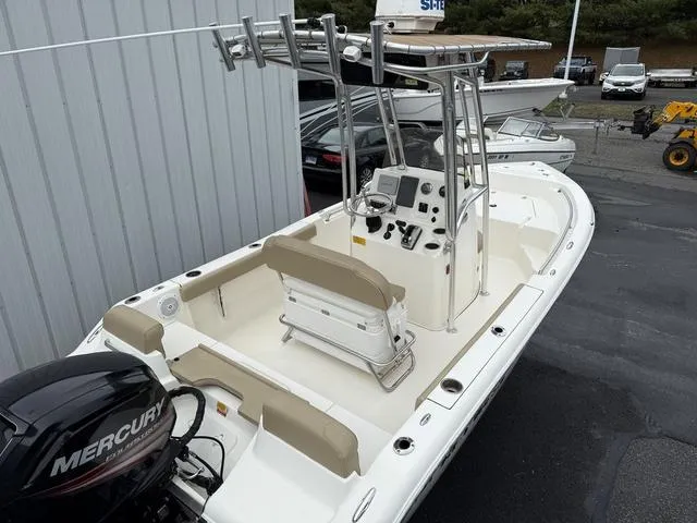Slide: The Image of 2016 Key West 189FS boat with Mercury engine, docked near a building. - 6