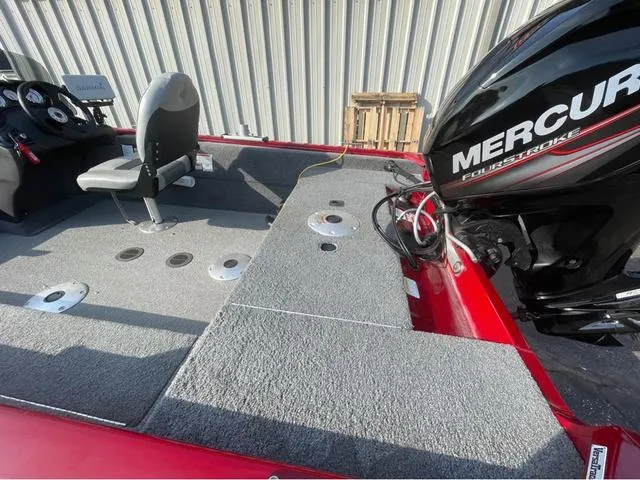 Slide: The Image of 2019 Tracker Super Guide V-16 SC boat interior with Mercury engine, gray carpet, and seating. - 7
