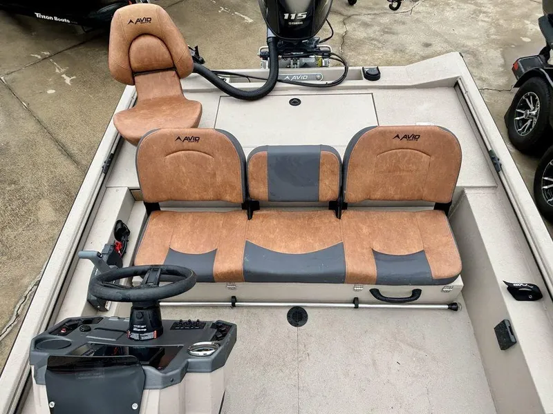 Slide: The Image of 2025 Avid 18 Rogue SC boat interior with tan and gray seating, steering console, and Yamaha motor. - 4