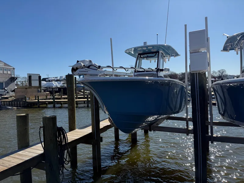 Slide: The Image of 2024 Sportsman Heritage 231 Center Console boat docked on a sunny day. - 1