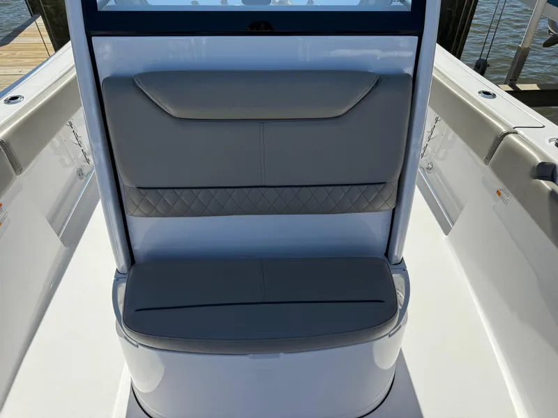 Slide: The Image of 2024 Sportsman Heritage 231 Center Console boat seating area, featuring cushioned seats and sleek design. - 18