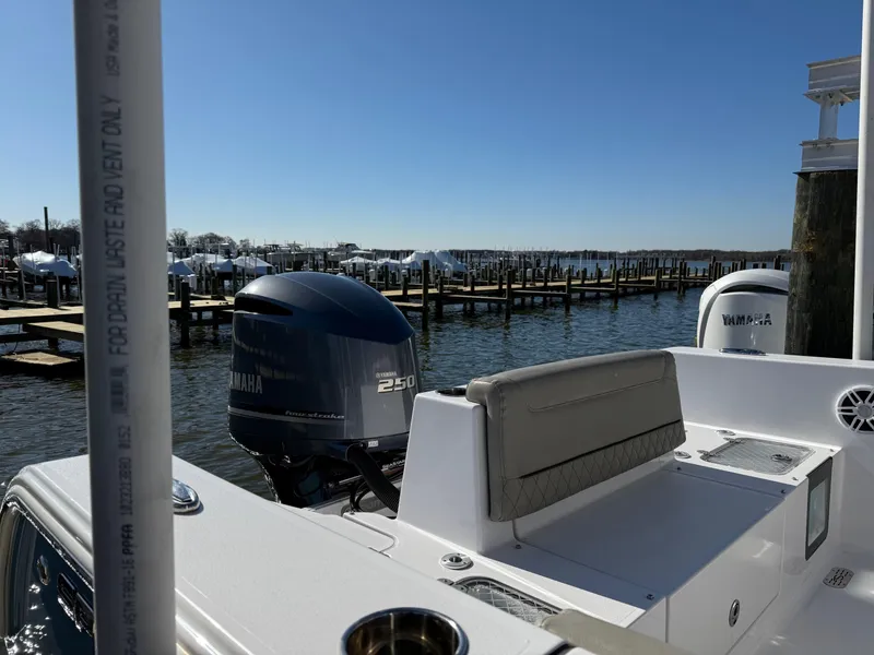 Slide: The Image of 2024 Sportsman Heritage 231 Center Console boat with Yamaha 250 engine at marina. - 3