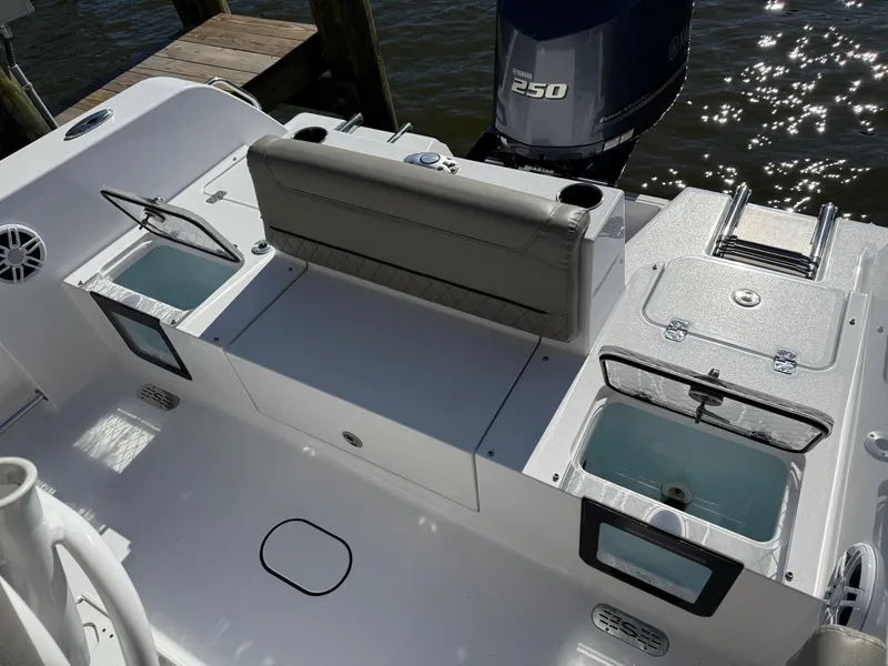 Slide: The Image of 2024 Sportsman Heritage 231 Center Console boat interior with seating and storage compartments. - 4