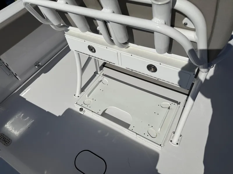 Slide: The Image of 2024 Sportsman Heritage 231 Center Console boat interior with rod holders and storage compartments. - 9