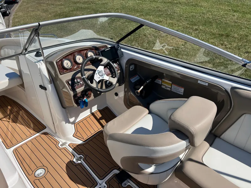 Slide: The Image of 2008 Yamaha Boats 232 Limited cockpit with steering wheel and dashboard, featuring wood-style flooring. - 15