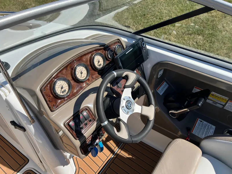 Slide: The Image of 2008 Yamaha Boats 232 Limited dashboard with steering wheel and gauges. - 16
