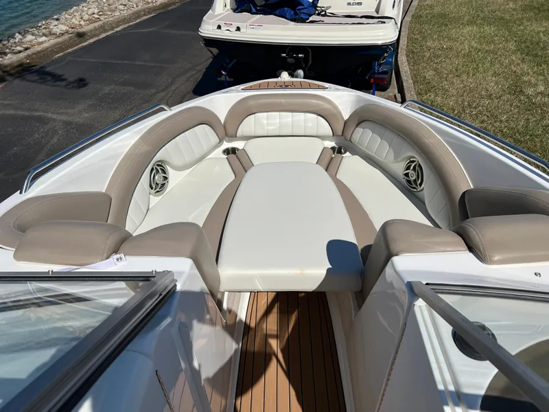 Slide: The Image of 2008 Yamaha Boats 232 Limited bow seating area with beige and white upholstery. - 18