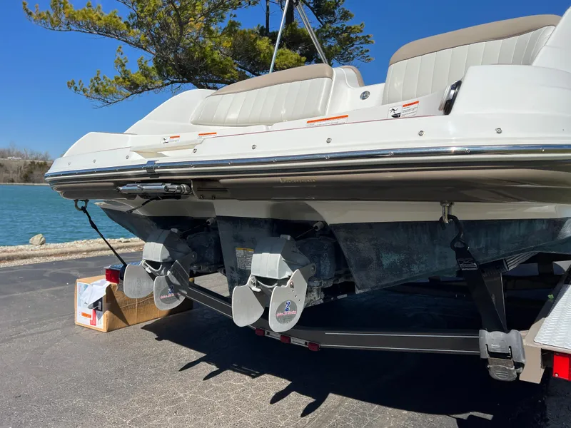 Slide: The Image of 2008 Yamaha Boats 232 Limited, rear view, parked near a lake on a sunny day. - 5