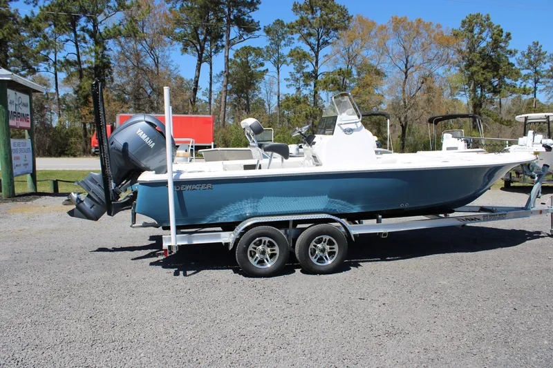 Slide: The Image of 2025 Tidewater 2110 Bay Max boat on trailer, parked outdoors. - 16
