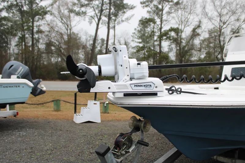 Slide: The Image of 2025 Tidewater 2110 Bay Max boat with Minn Kota trolling motor in a wooded area. - 20