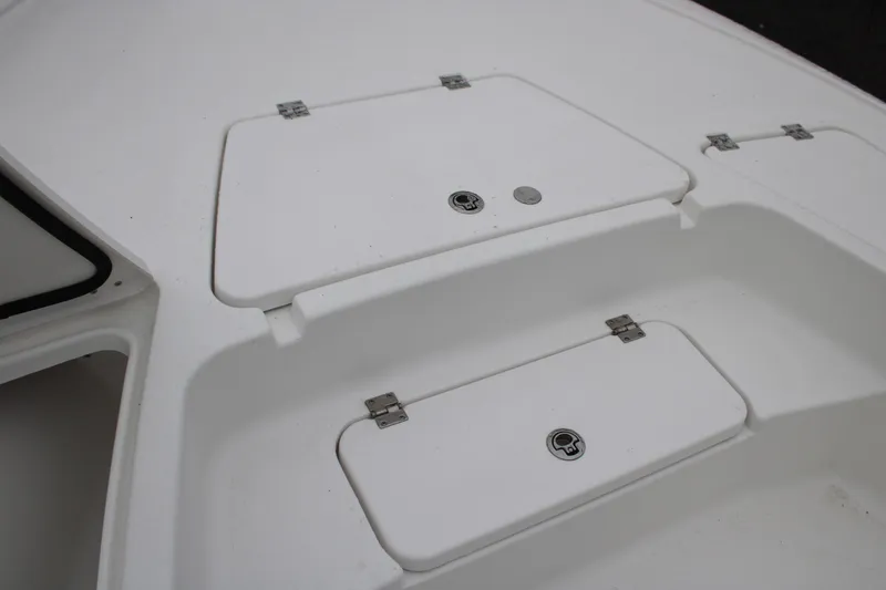 Slide: The Image of 2025 Tidewater 2110 Bay Max boat storage compartments, white deck view. - 23