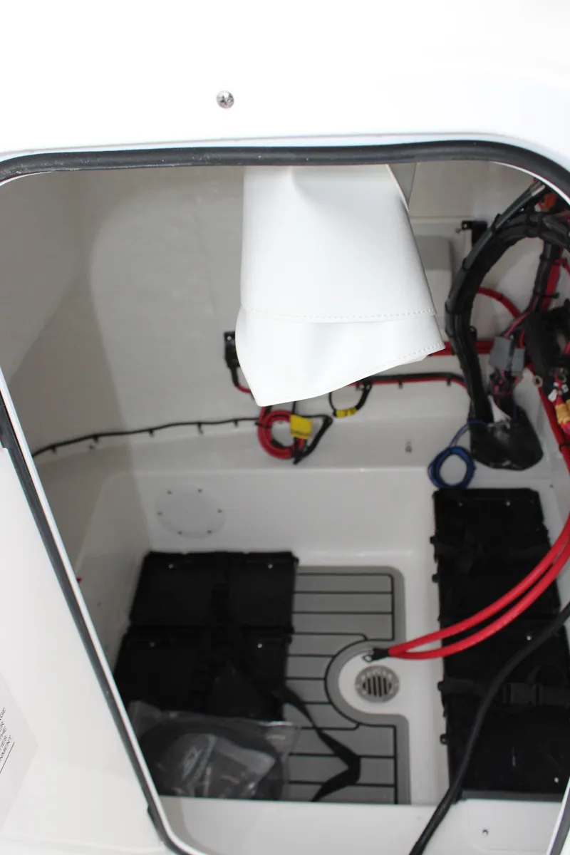 Slide: The Image of 2025 Tidewater 2110 Bay Max boat compartment with wiring and battery setup. - 24