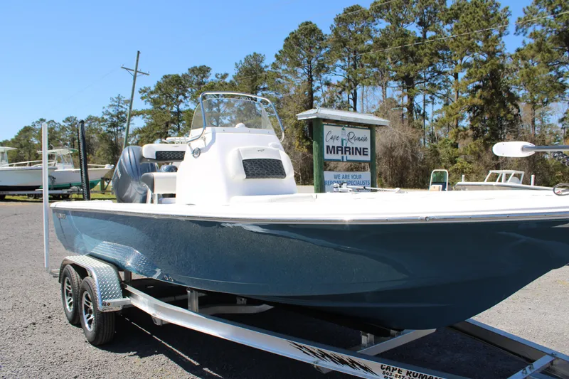 Slide: The Image of 2025 Tidewater 2110 Bay Max boat on trailer, parked outdoors near trees. - 3