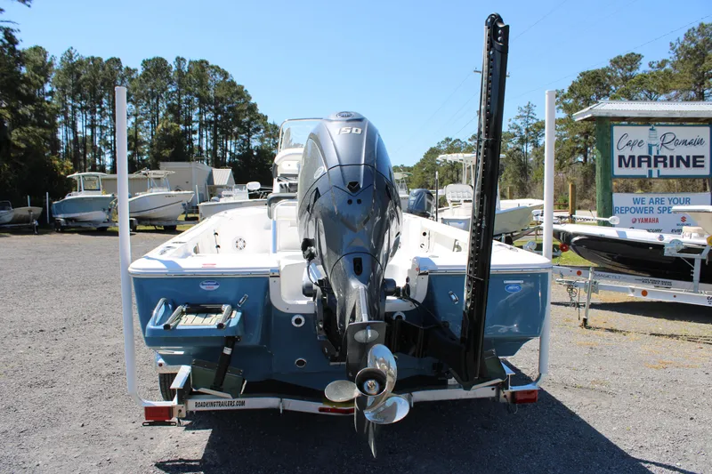 Slide: The Image of 2025 Tidewater 2110 Bay Max boat with outboard motor, parked at a marine dealership. - 4