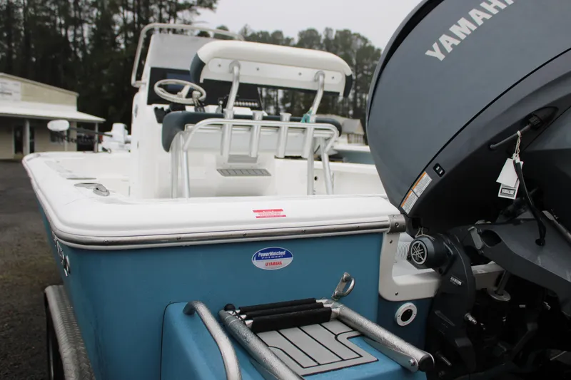 Slide: The Image of 2025 Tidewater 2110 Bay Max boat with Yamaha engine, docked outdoors. - 7