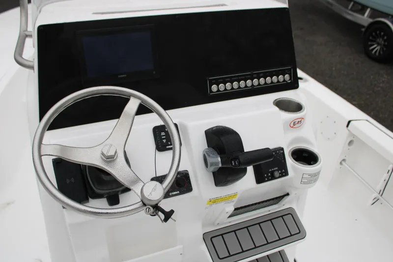 Slide: The Image of 2025 Tidewater 2110 Bay Max boat console with steering wheel and controls. - 8