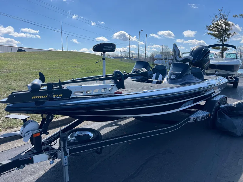 Slide: The Image of 2018 Skeeter ZX 225 fishing boat on trailer, parked outdoors under blue sky. - 10