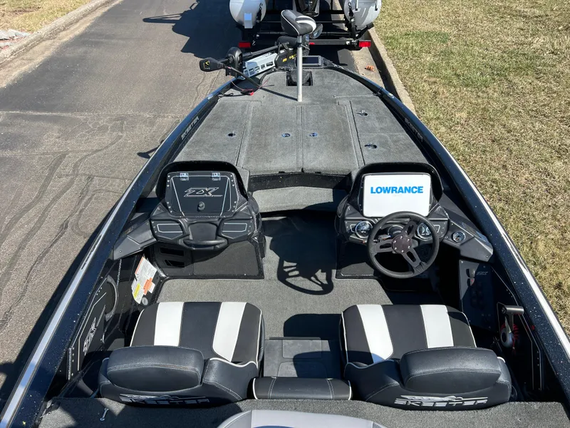 Slide: The Image of 2018 Skeeter ZX 225 boat interior with Lowrance electronics and dual seating. - 12