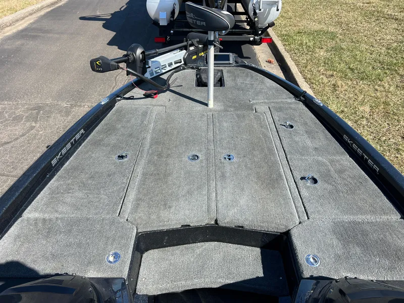 Slide: The Image of 2018 Skeeter ZX 225 boat deck with trolling motor, parked on a sunny day. - 19