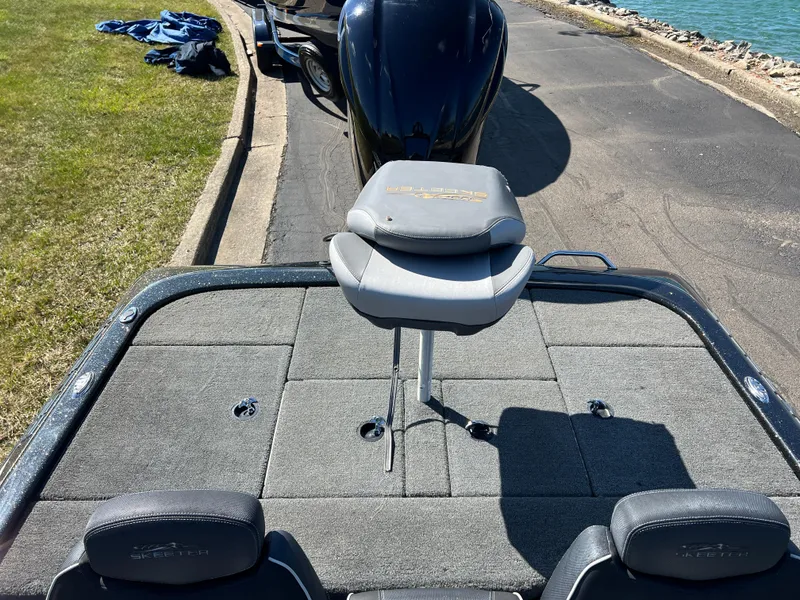 Slide: The Image of 2018 Skeeter ZX 225 boat with seating, parked near a waterfront. - 24