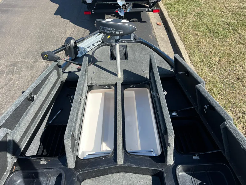 Slide: The Image of 2018 Skeeter ZX 225 boat interior with open storage compartments and trolling motor. - 25