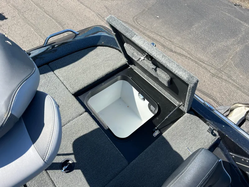 Slide: The Image of 2018 Skeeter ZX 225 boat with open storage compartment, gray seating, and carpeted interior. - 26