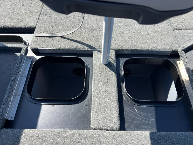 Slide: The Image of 2018 Skeeter ZX 225 boat storage compartments with open lids, showcasing interior space. - 28