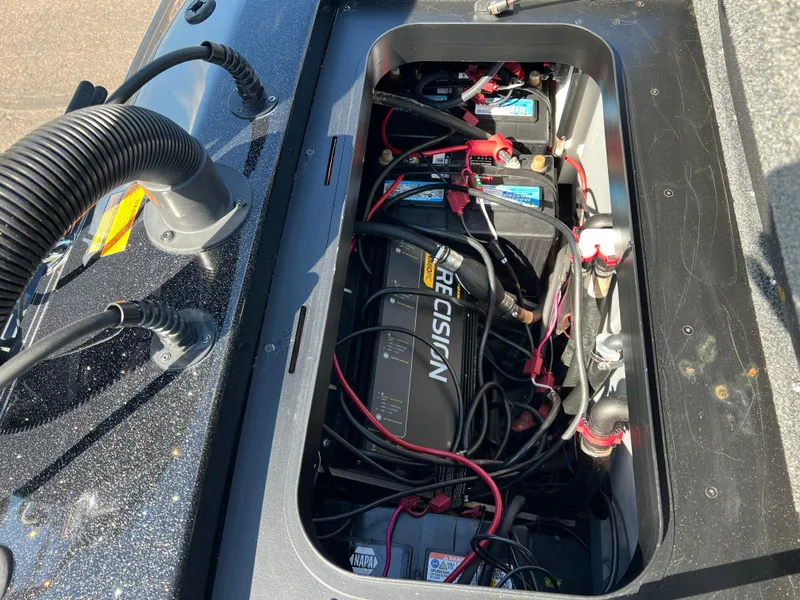 Slide: The Image of 2018 Skeeter ZX 225 boat battery compartment with wiring and components. - 30