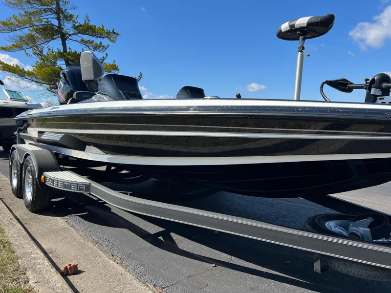 Slide: The Image of 2018 Skeeter ZX 225 bass boat on trailer, parked outdoors under clear blue sky. - 4