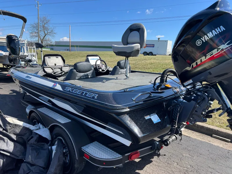 Slide: The Image of 2018 Skeeter ZX 225 bass boat with Yamaha engine, parked outdoors on a sunny day. - 8