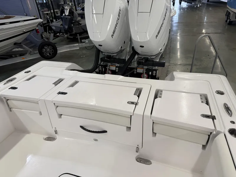 Slide: The Image of 2025 Tidewater 3100 Carolina Bay boat with dual Mercury engines in showroom. - 11