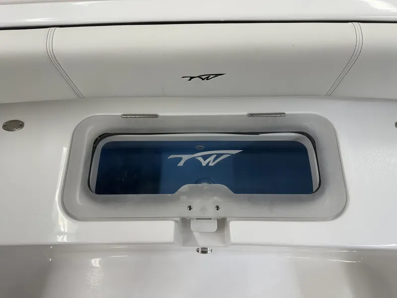 Slide: The Image of 2025 Tidewater 3100 Carolina Bay boat interior with logo and storage compartment. - 15