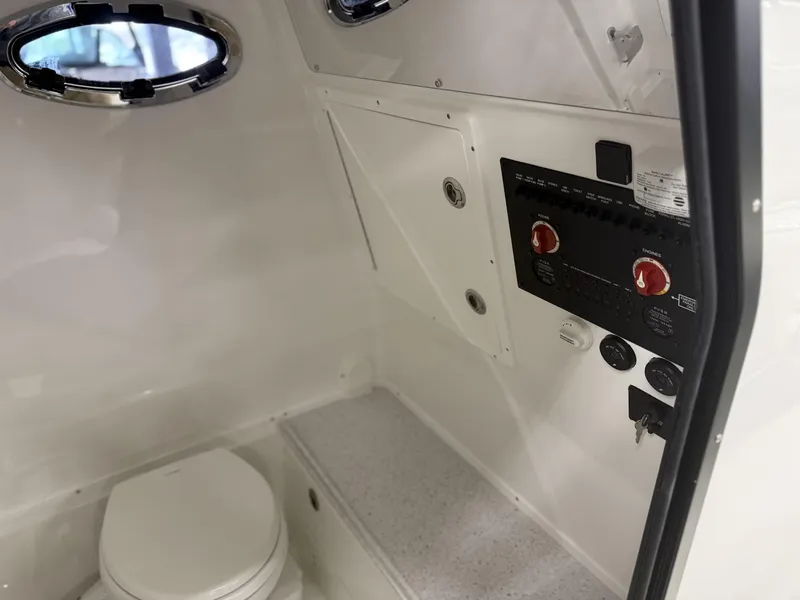 Slide: The Image of Interior of 2025 Tidewater 3100 Carolina Bay boat with control panel and toilet. - 18