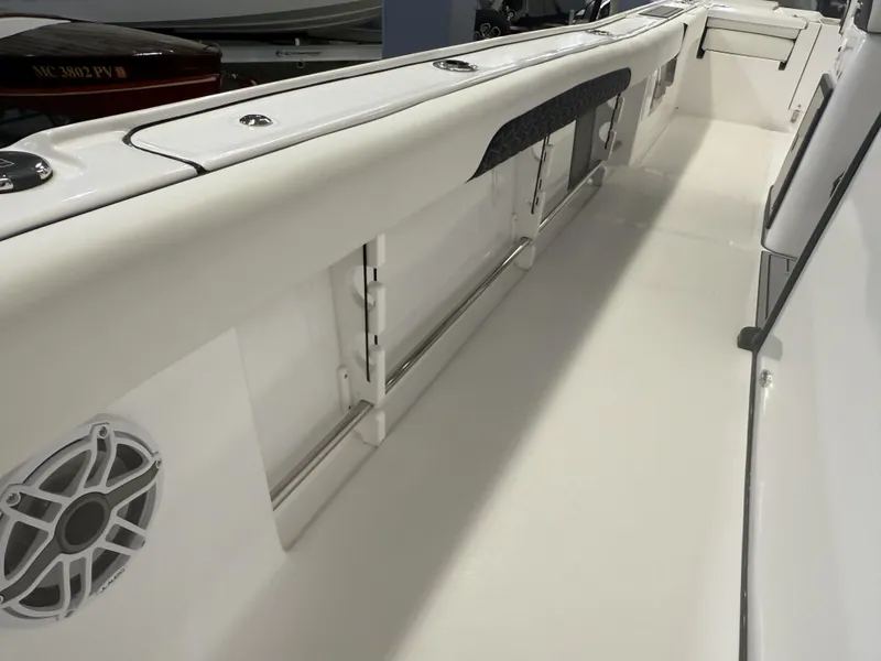 Slide: The Image of 2025 Tidewater 3100 Carolina Bay boat interior with sleek white design and speaker system. - 23