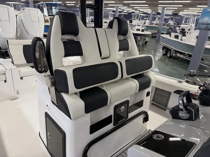 Slide: The Image of 2025 Tidewater 3100 Carolina Bay boat interior with modern seating and control panel. - 24