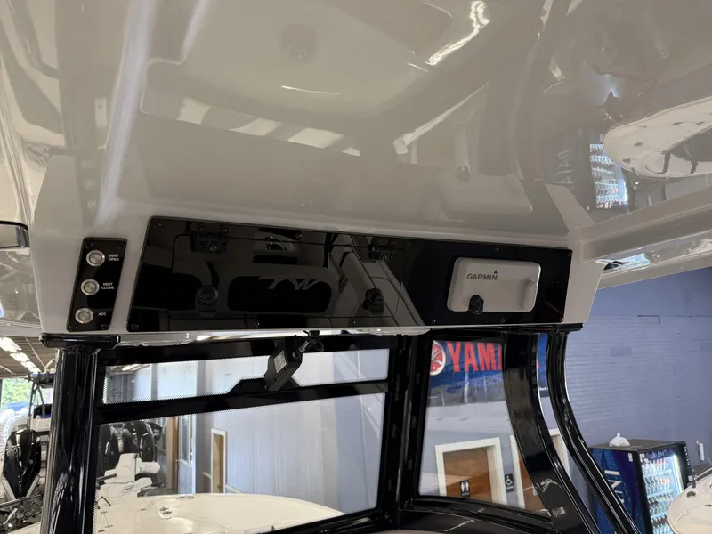 Slide: The Image of 2025 Tidewater 3100 Carolina Bay boat console with Garmin electronics and control panel. - 27