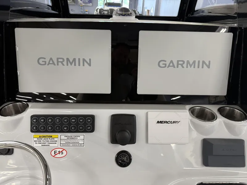 Slide: The Image of 2025 Tidewater 3100 Carolina Bay dashboard with dual Garmin screens and Mercury controls. - 31