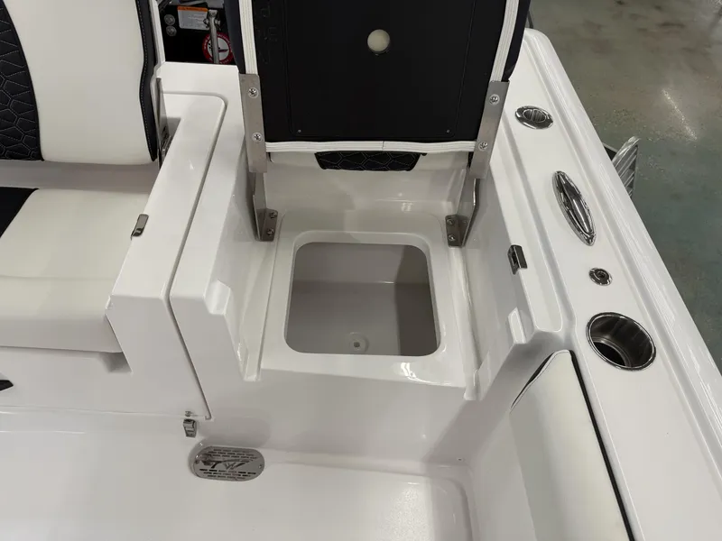 Slide: The Image of 2025 Tidewater 3100 Carolina Bay boat interior with storage compartment and seating. - 7