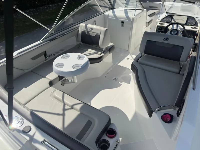 Slide: The Image of 2022 Hurricane SunDeck 235 OB boat interior with seating and table. - 10