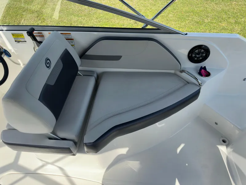 Slide: The Image of 2022 Hurricane SunDeck 235 OB boat interior with cushioned seating and speaker. - 16